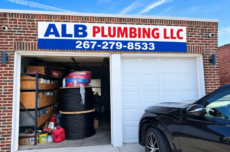 AlbPlumbing LLC shop on E Thompson St in Philadelphia with the company sign over the garage