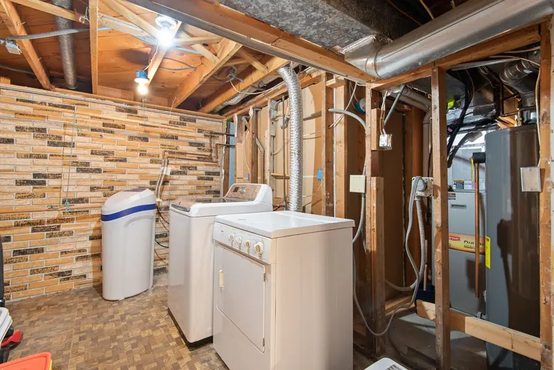 Basement utility room with laundry and water equipment