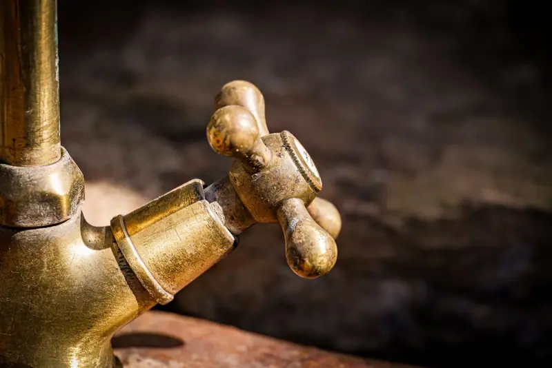 Old brass faucet handle up close