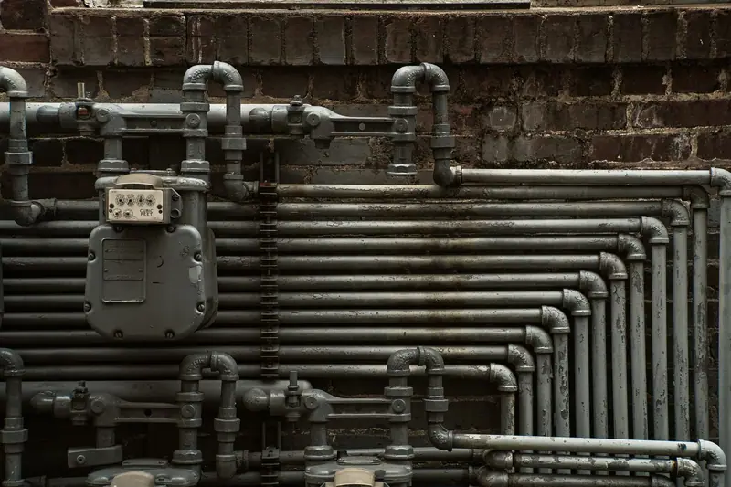 Gas meter and steel gas piping on a brick wall