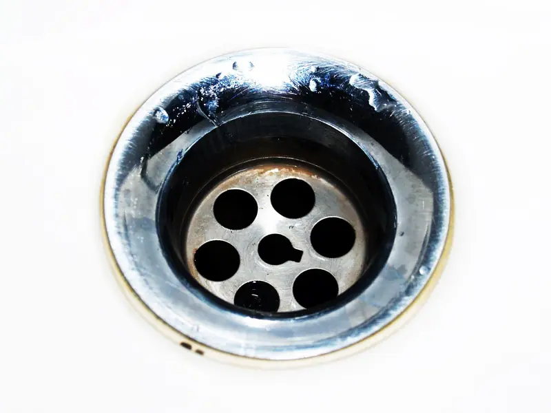 Chrome sink drain with water droplets